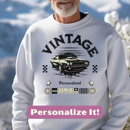 an older man wearing a white sweater with a car on it