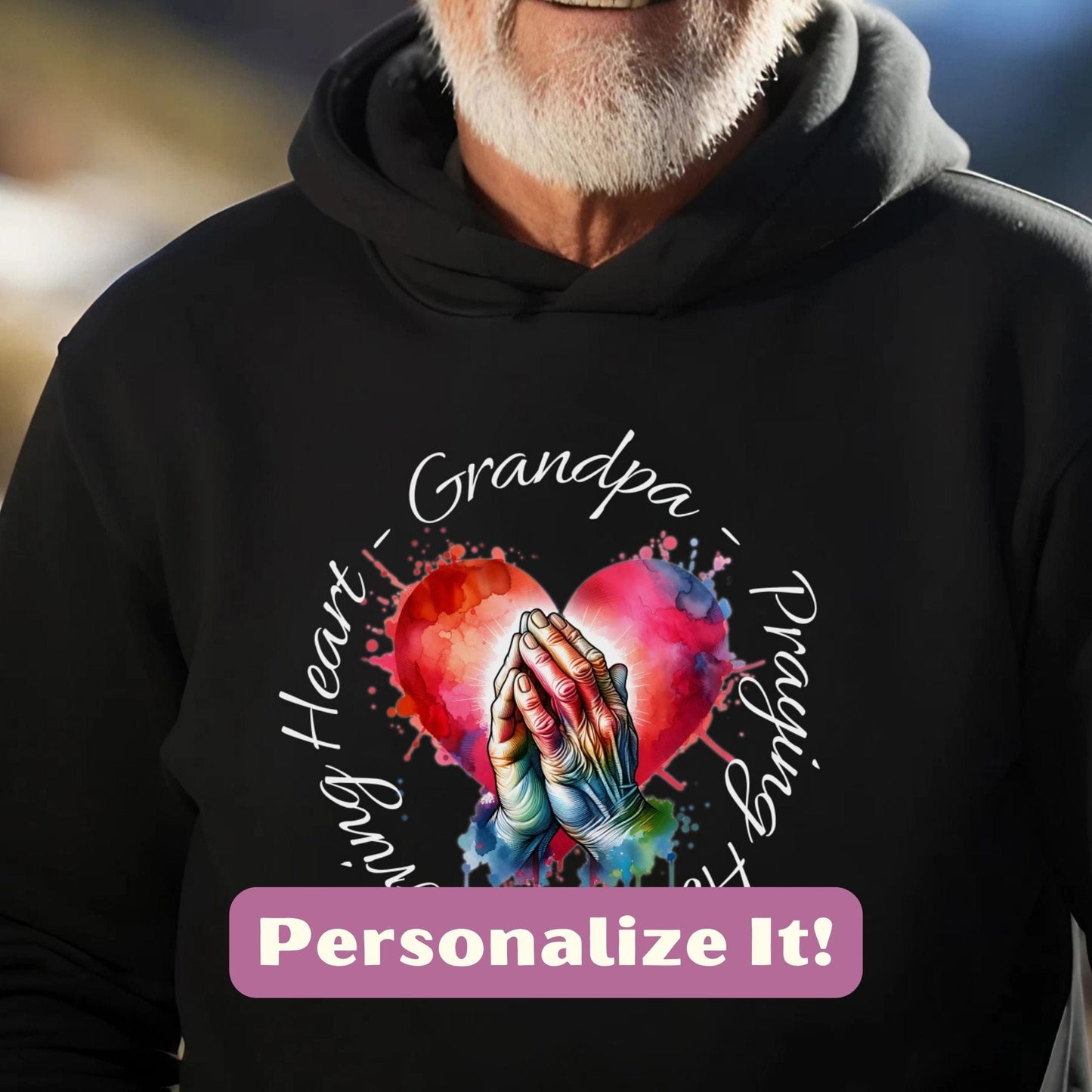 a man wearing a black hoodie with a heart and hands on it