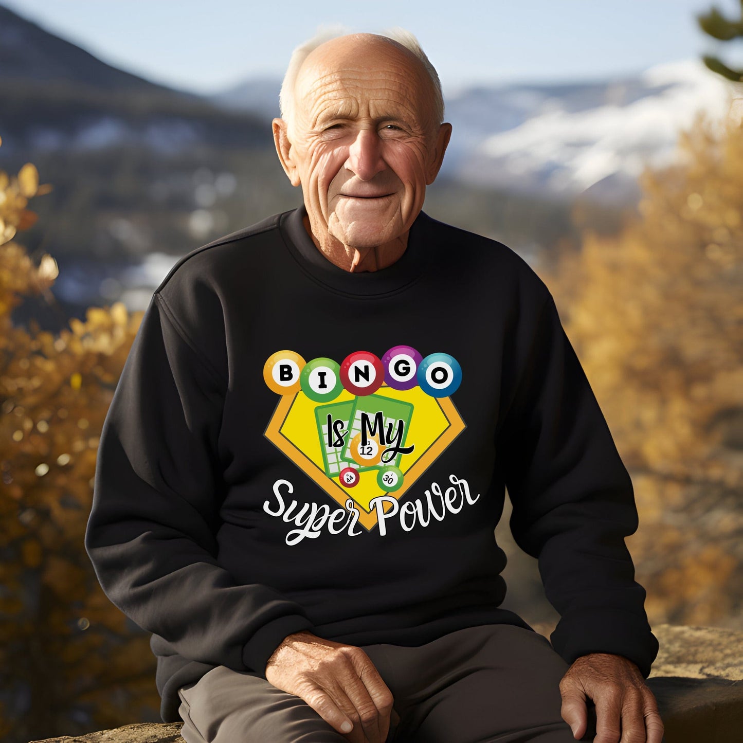 an older man sitting on a ledge wearing a black sweatshirt