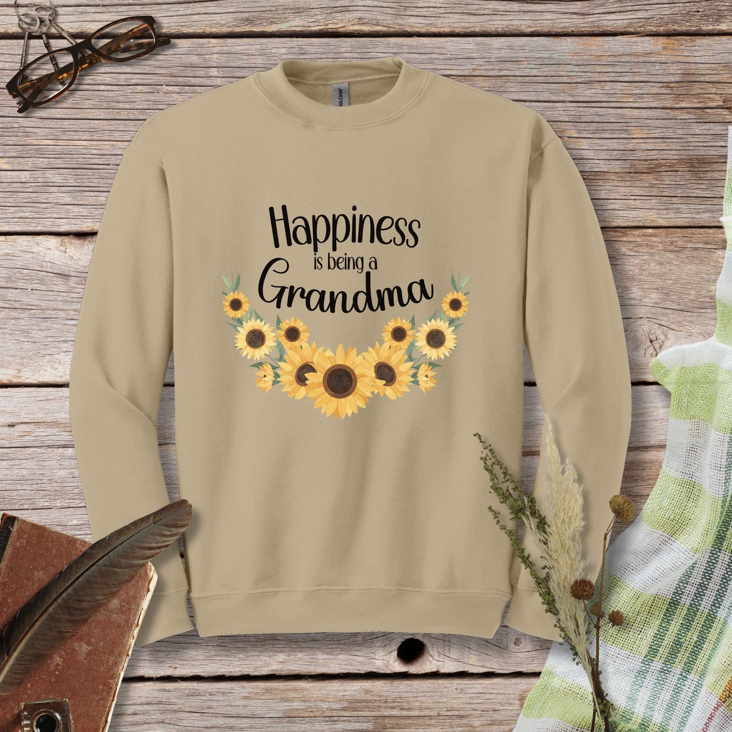 a sweatshirt with sunflowers and the words happiness is being a grandma