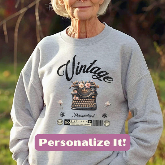 an old woman wearing a sweatshirt with a typewriter on it