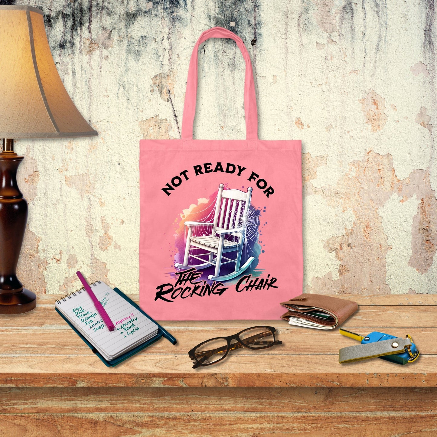 a pink tote bag sitting on top of a wooden table