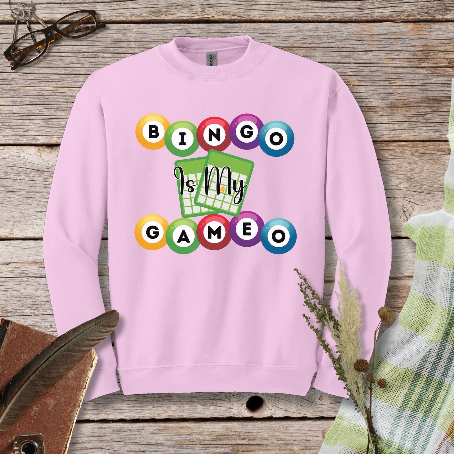 a pink sweatshirt with a game design on it