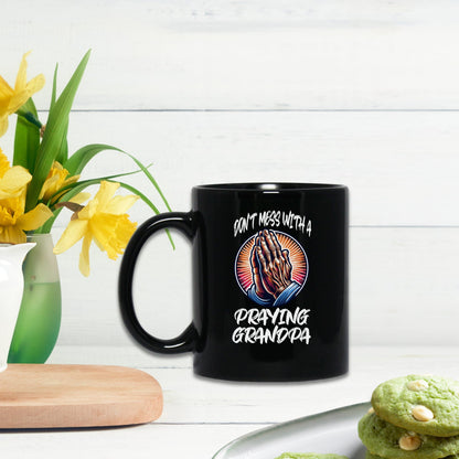 a black coffee mug sitting on top of a table