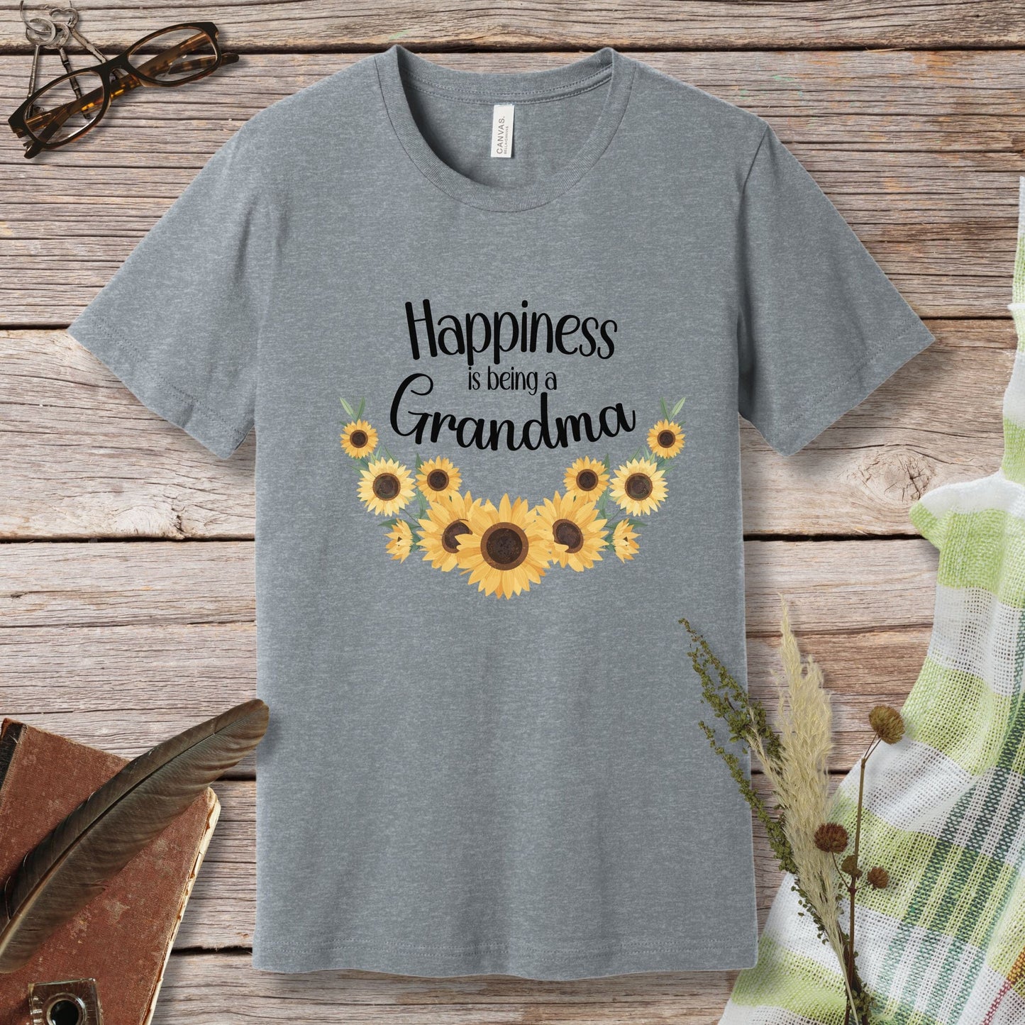 a gray t - shirt with sunflowers and the words happiness is being grandma