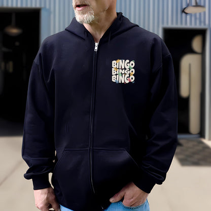 a man in a black hoodie is standing in front of a building