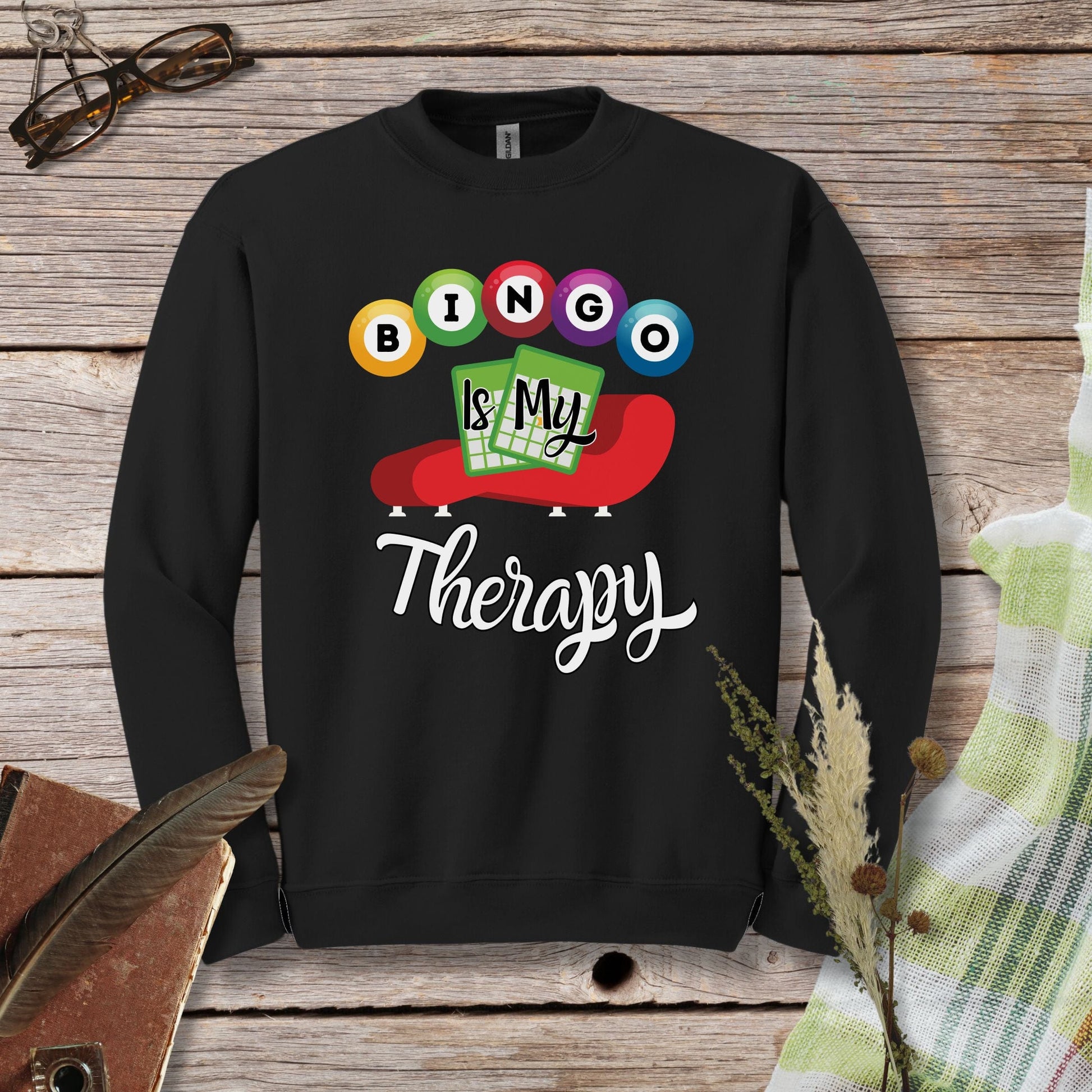 a black sweatshirt with the words bingo is my therapy on it