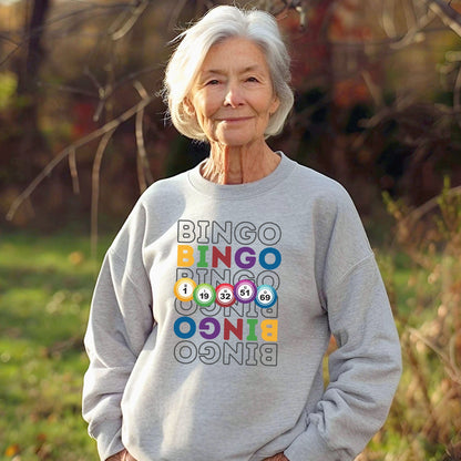 an older woman standing in a field with her hands in her pockets