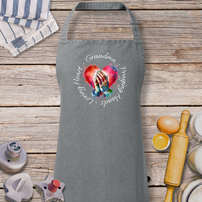 a gray apron with a picture of a hand holding a heart