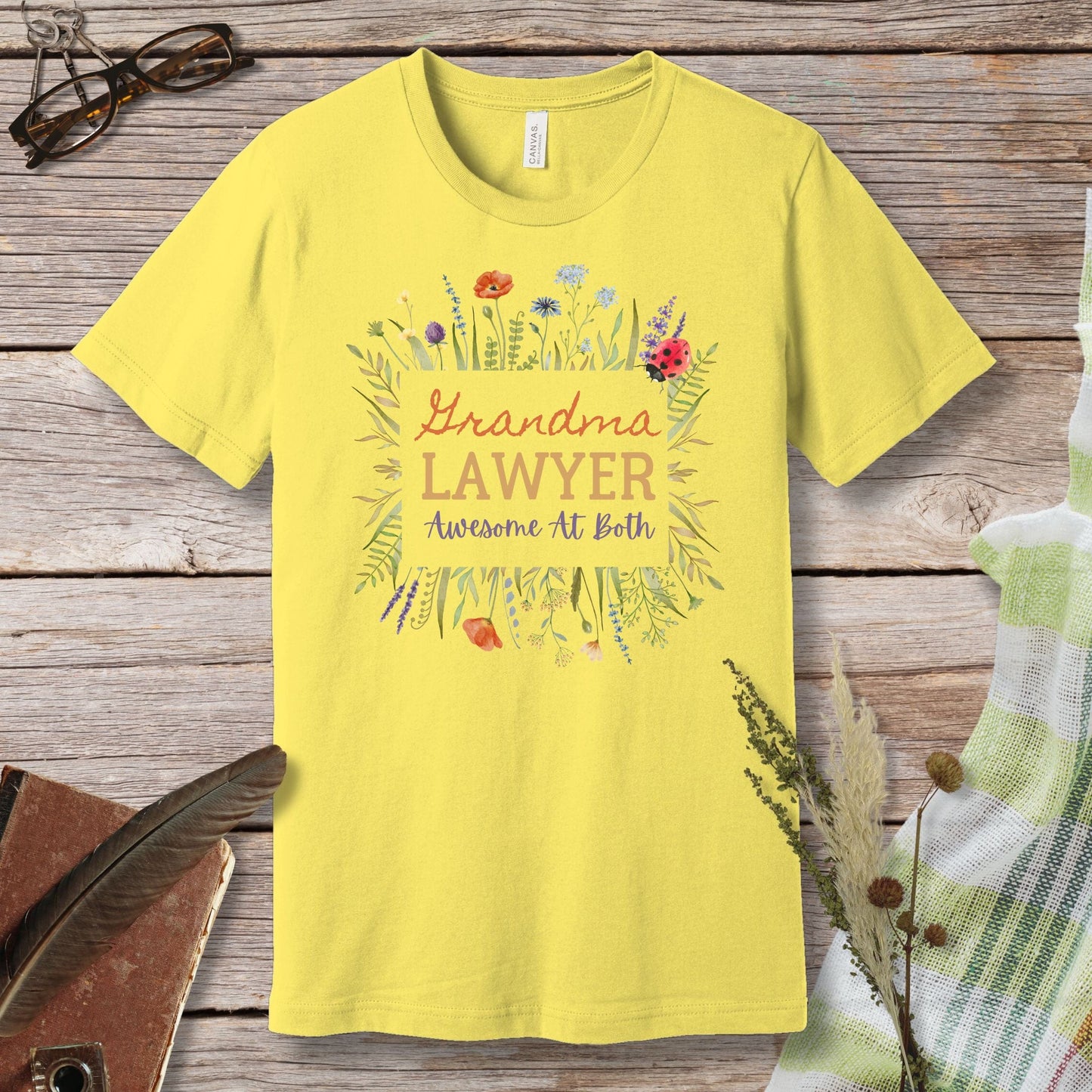 a yellow t - shirt that says grandma's lawyer awesome at birth