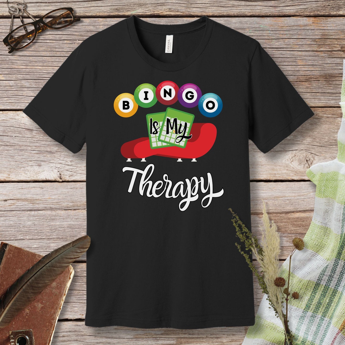 a black t - shirt that says bingo is my therapy