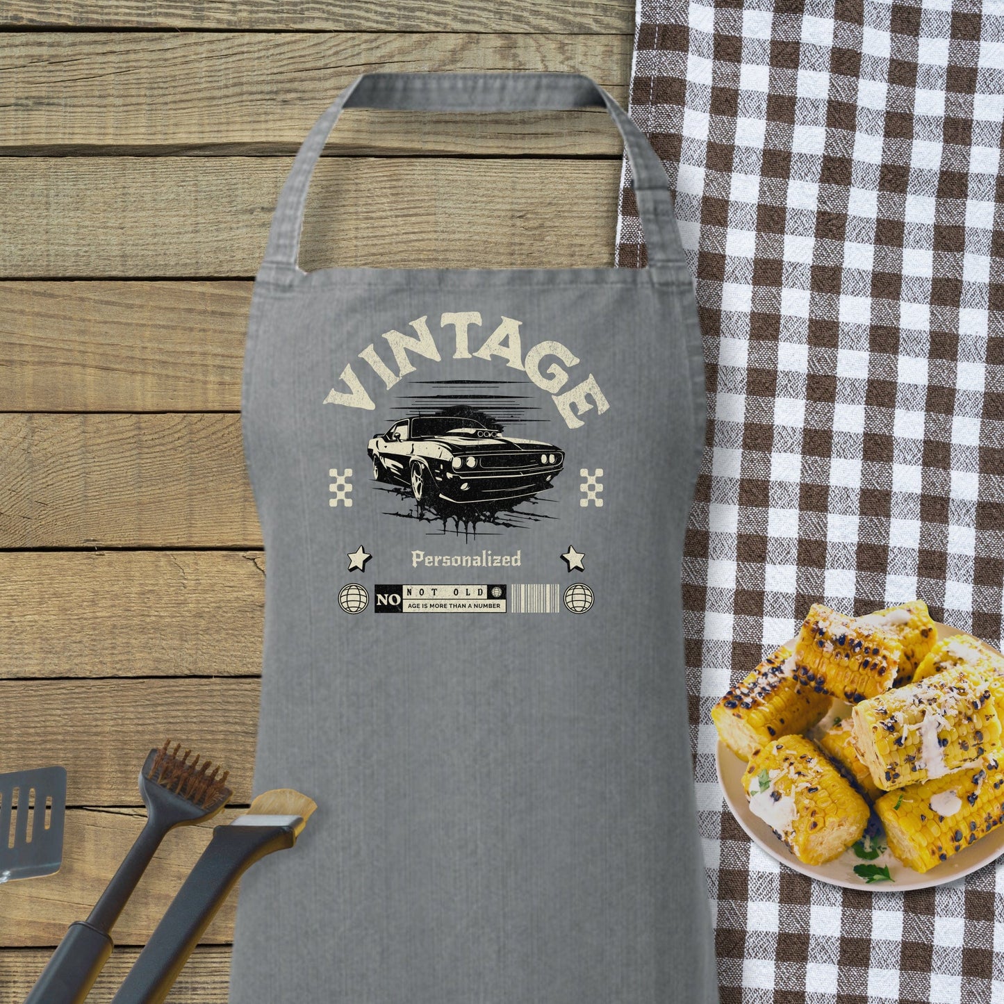 a gray apron sitting on top of a table next to a plate of food