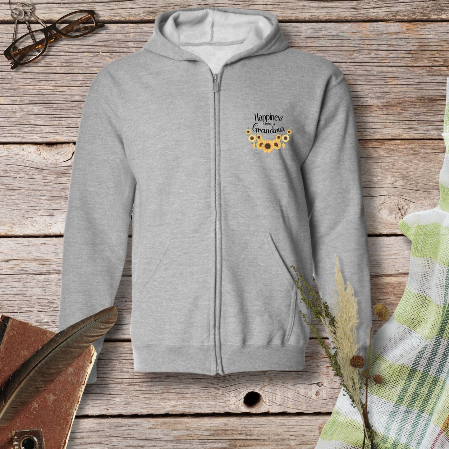 a gray sweatshirt with a sunflower embroidered on it