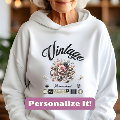 an older woman wearing a white hoodie with the words vintage on it