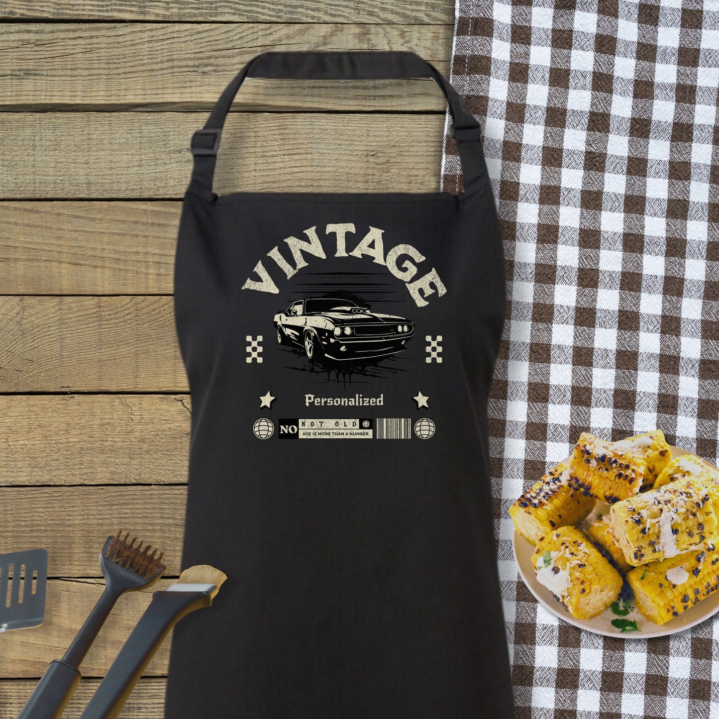 a black apron sitting on top of a table next to a plate of food