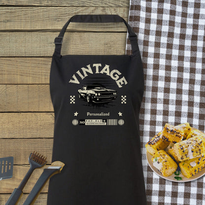 a black apron sitting on top of a table next to a plate of food