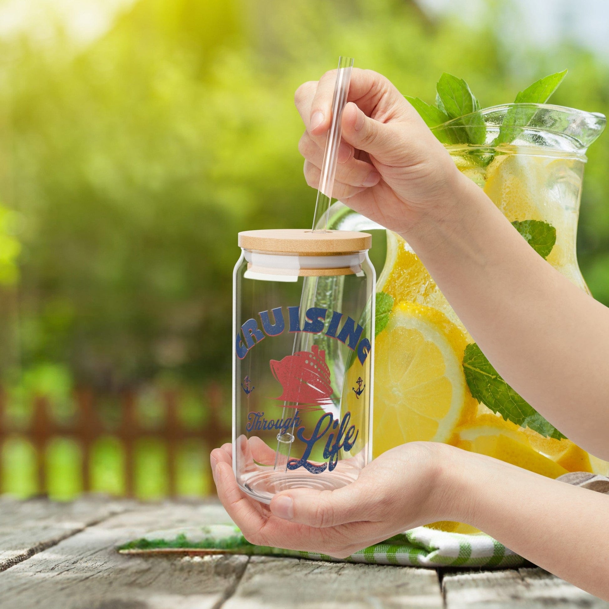 a person holding a jar of lemonade with a straw