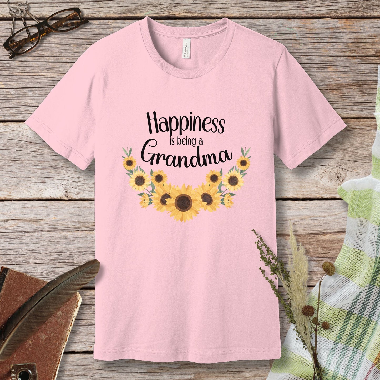 a pink t - shirt with sunflowers and the words happiness is being grandma