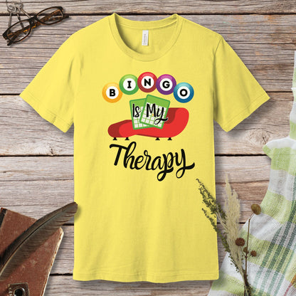 a yellow t - shirt that says bingo is my therapy