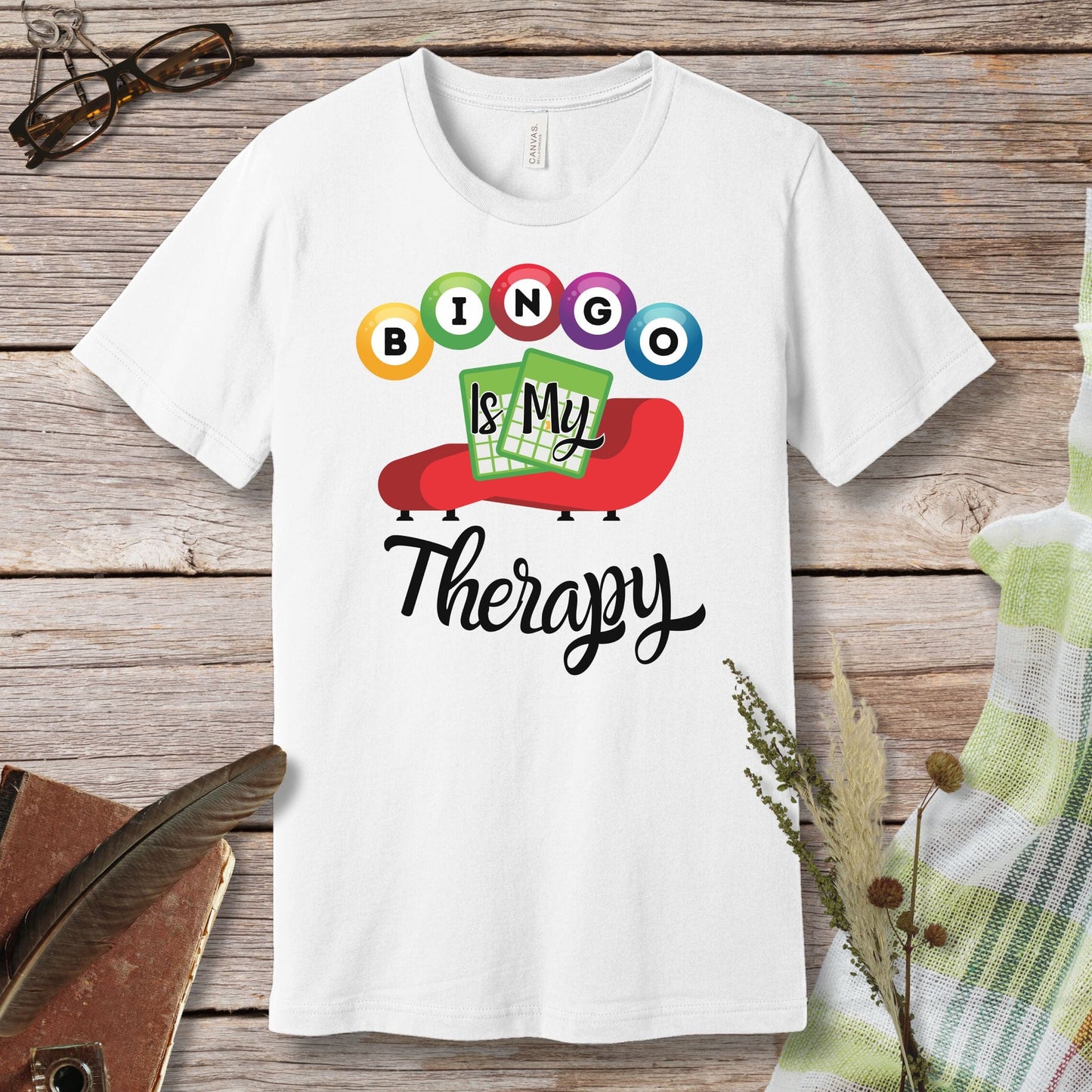 a white t - shirt with the words bingo is my therapy on it