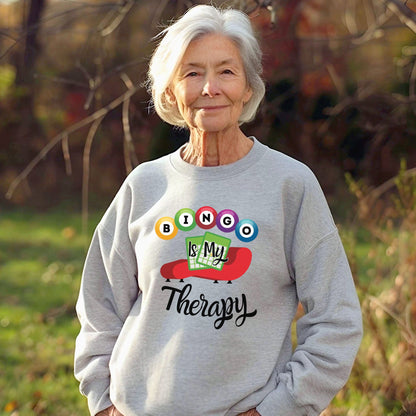 an older woman wearing a sweatshirt that says boo is my therapy