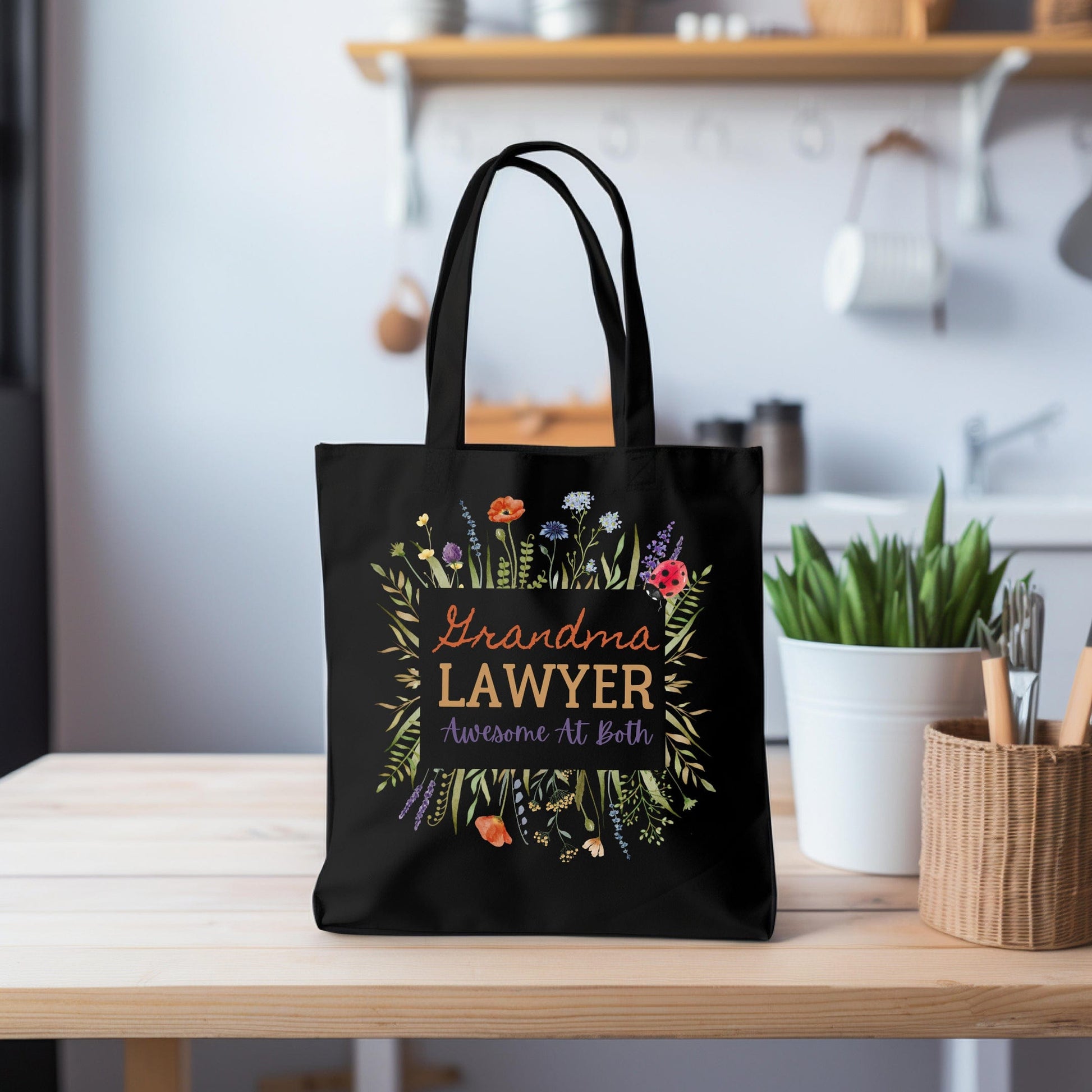 a black shopping bag with the words grandma's lawyer on it