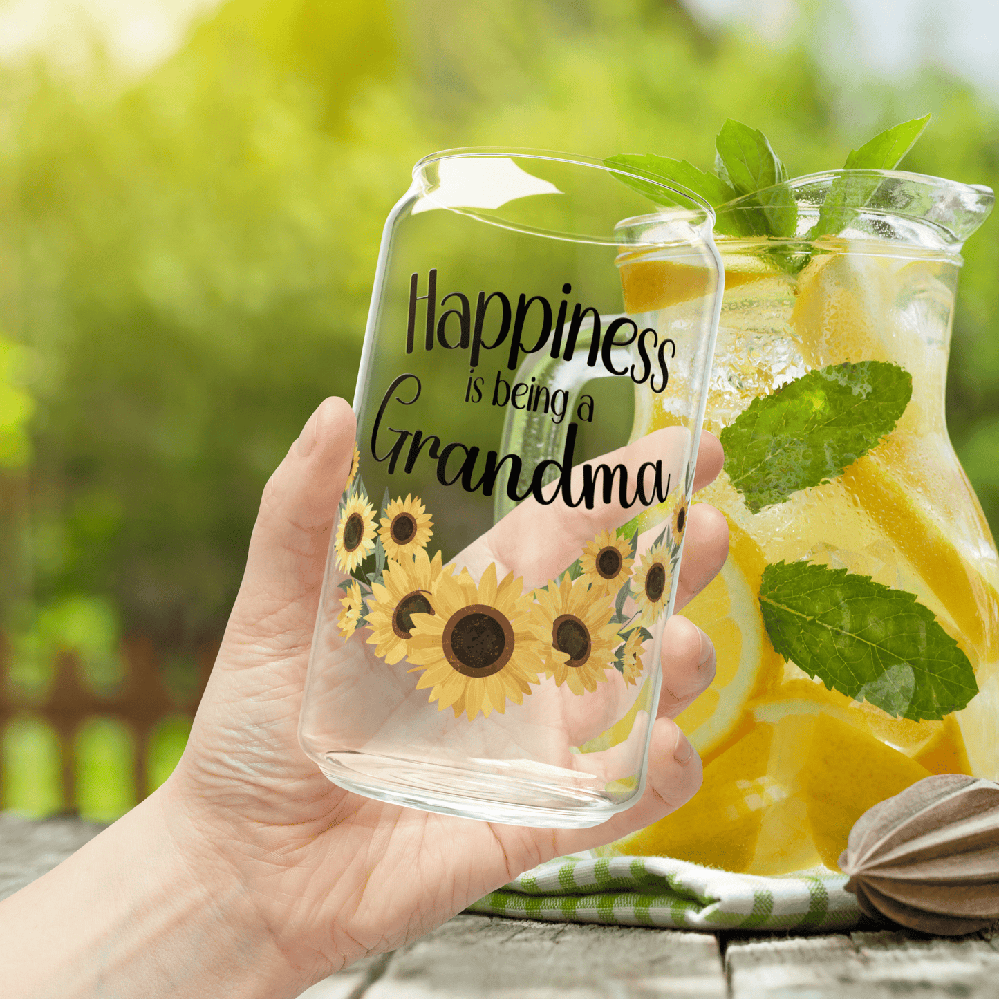 a person holding a glass with a sunflower on it