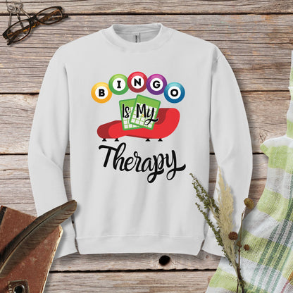 a white sweatshirt with the words bingo is my therapy on it