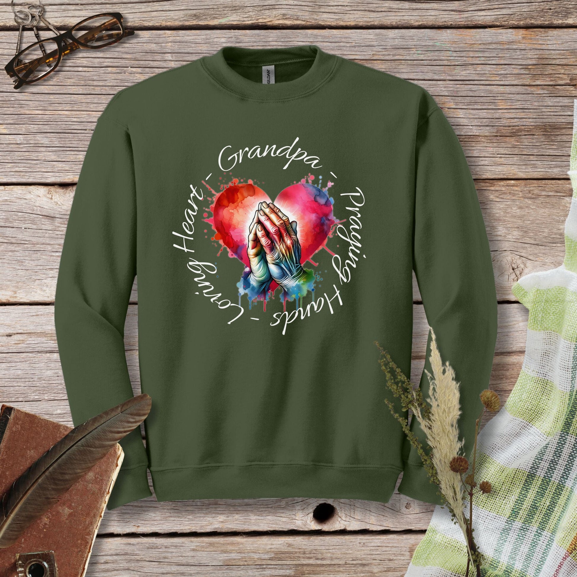 a green sweatshirt with a picture of a hand holding a heart