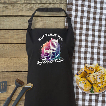 a black apron sitting on top of a table next to a plate of food