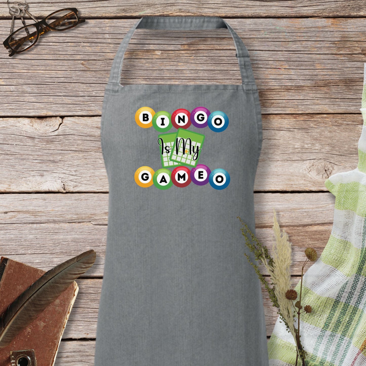 a gray apron with a picture of a hand holding a game controller