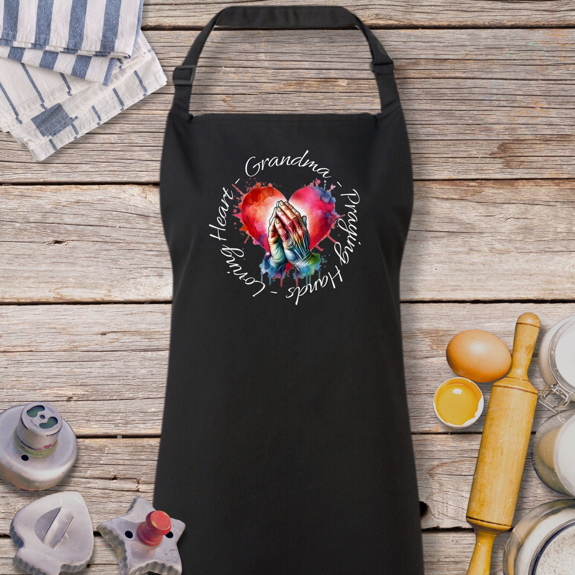 a black apron with a picture of a hand holding a heart