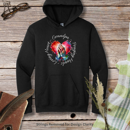 a black hoodie with an image of a woman's hands holding a heart