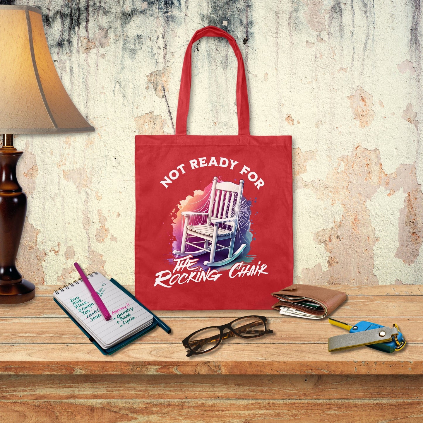 a red tote bag sitting on top of a wooden table