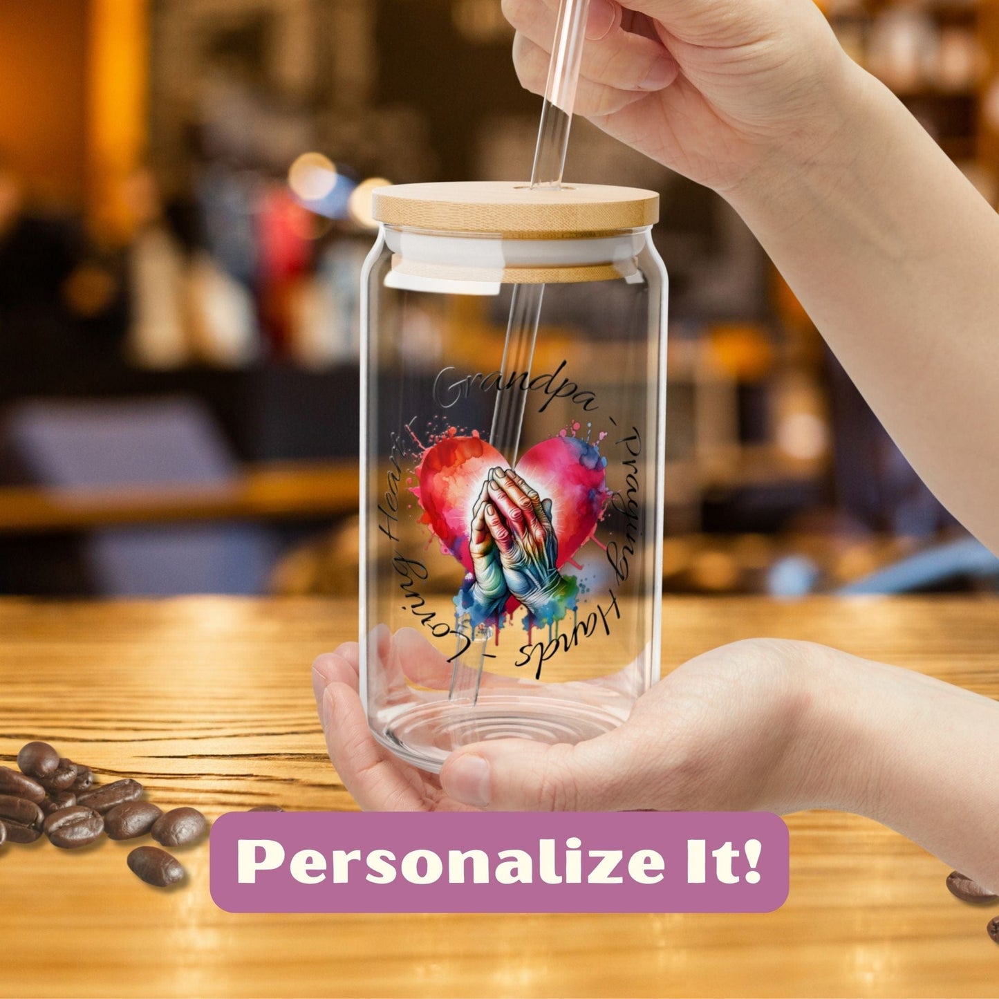 a person holding a glass jar with a picture on it