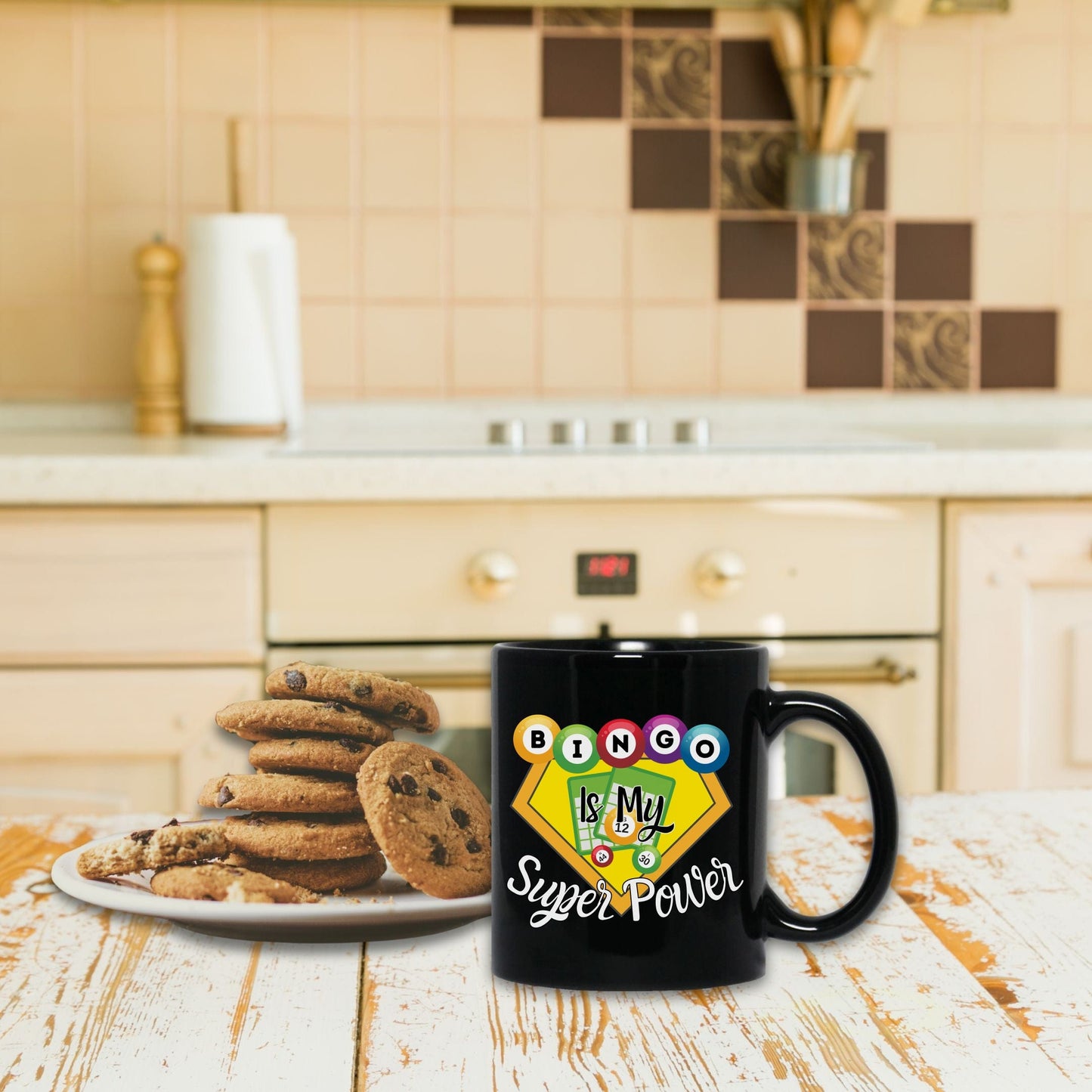 a black coffee mug sitting on top of a wooden table