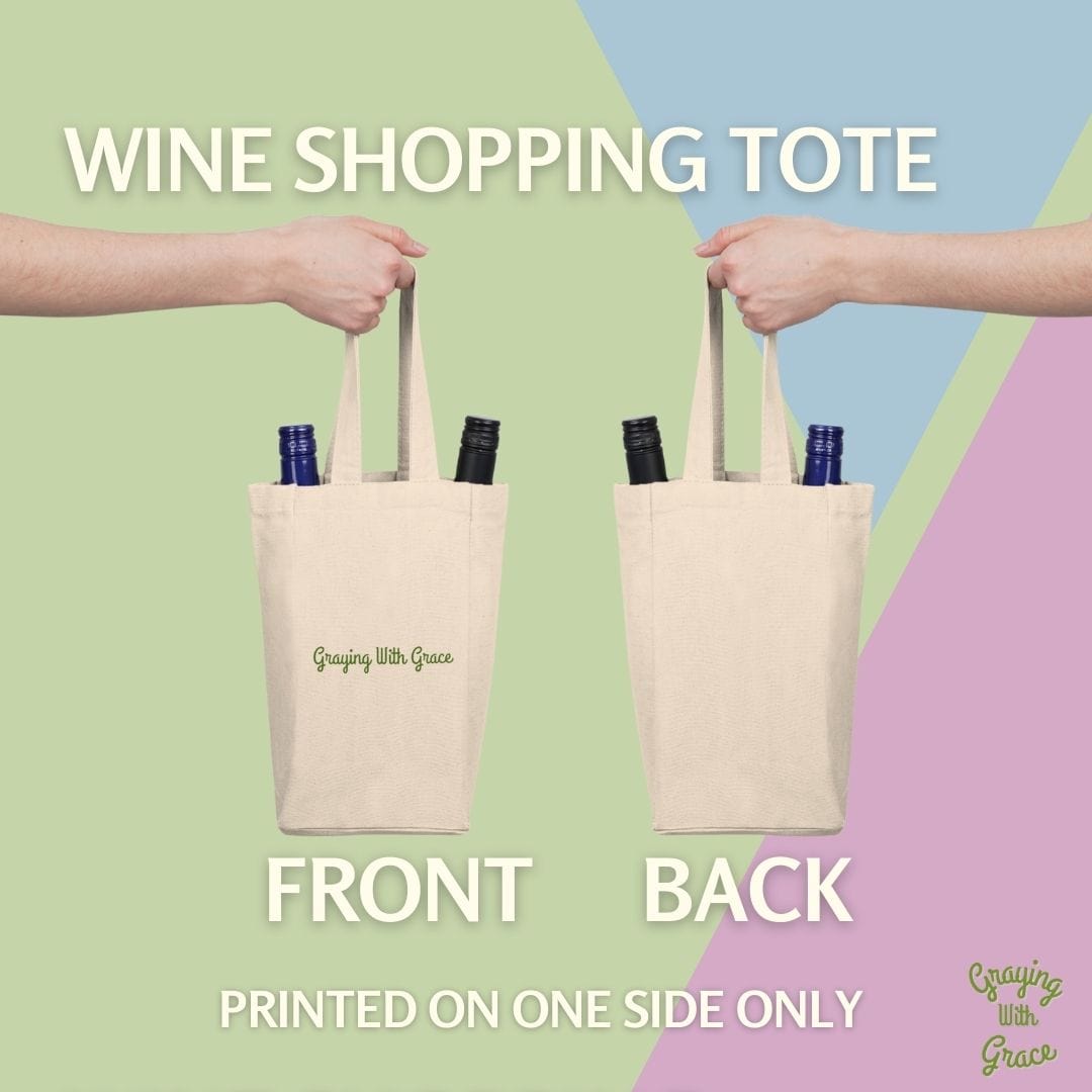 a pair of hands holding wine bottles in a tote bag