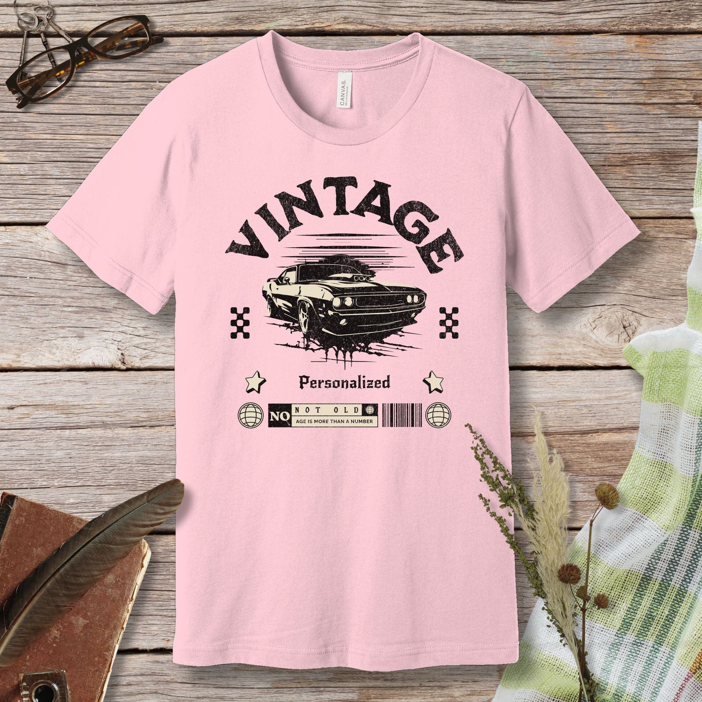 a pink t - shirt with a picture of a car on it