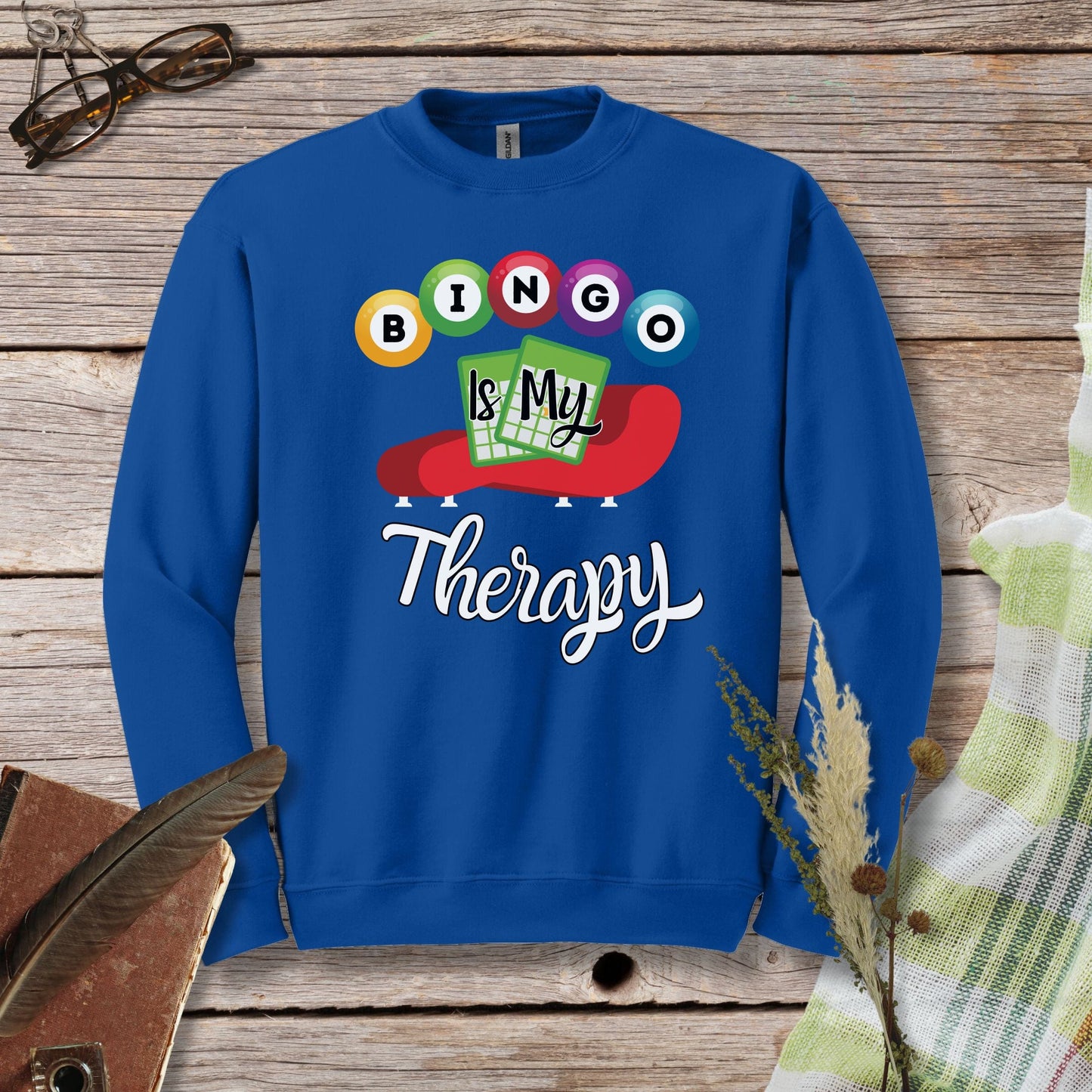 a blue sweatshirt with the words bingo is my therapy on it