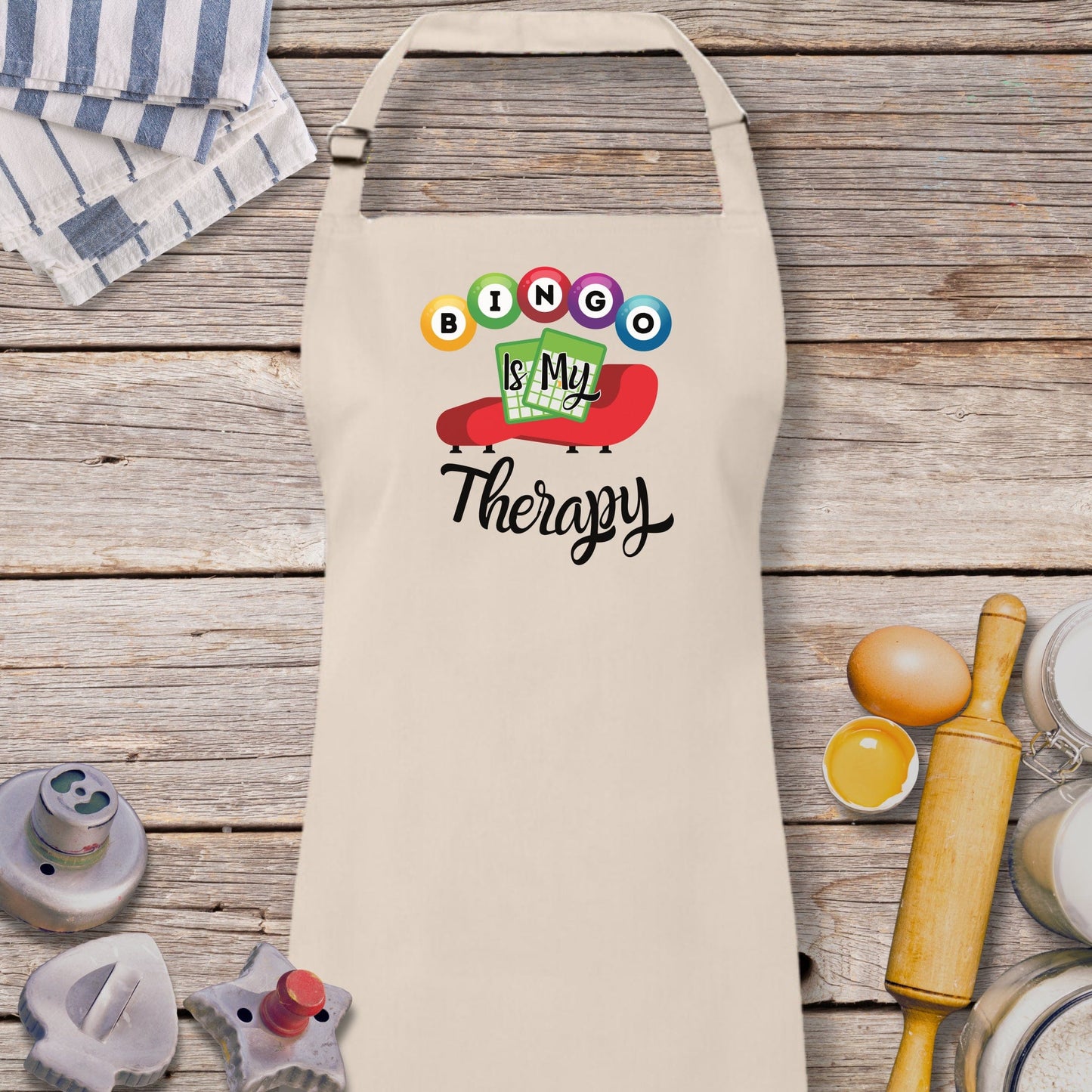 a white apron with the words boo is my therapy on it