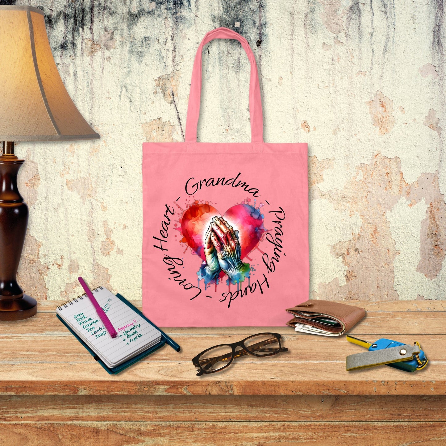 a pink tote bag with a picture of a hand holding a heart