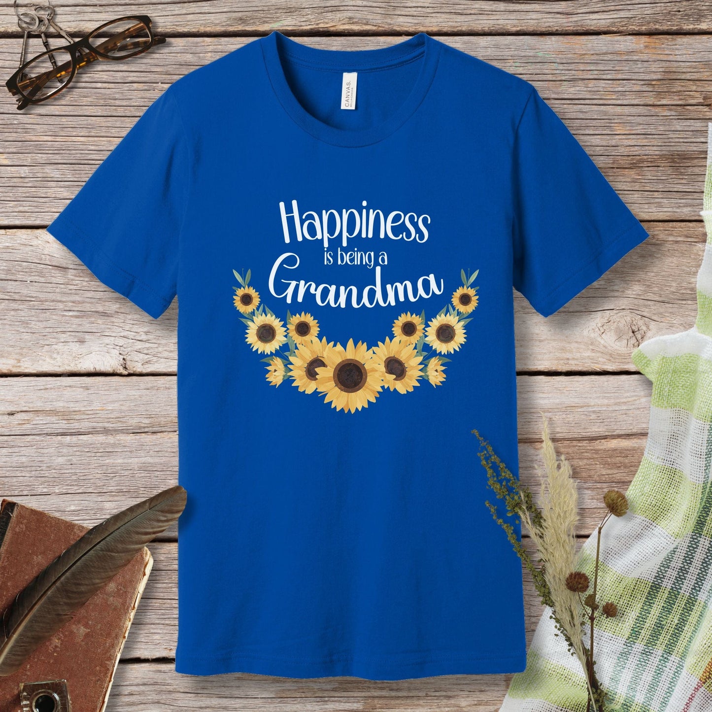 a blue t - shirt that says happiness is being a grandma with sunflowers