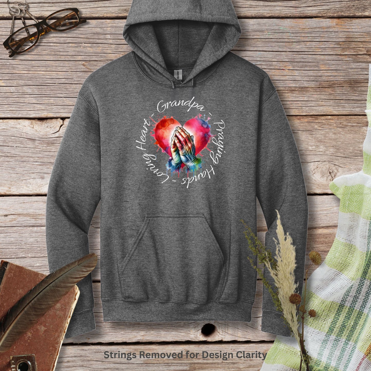 a gray hoodie with a heart and two hands on it