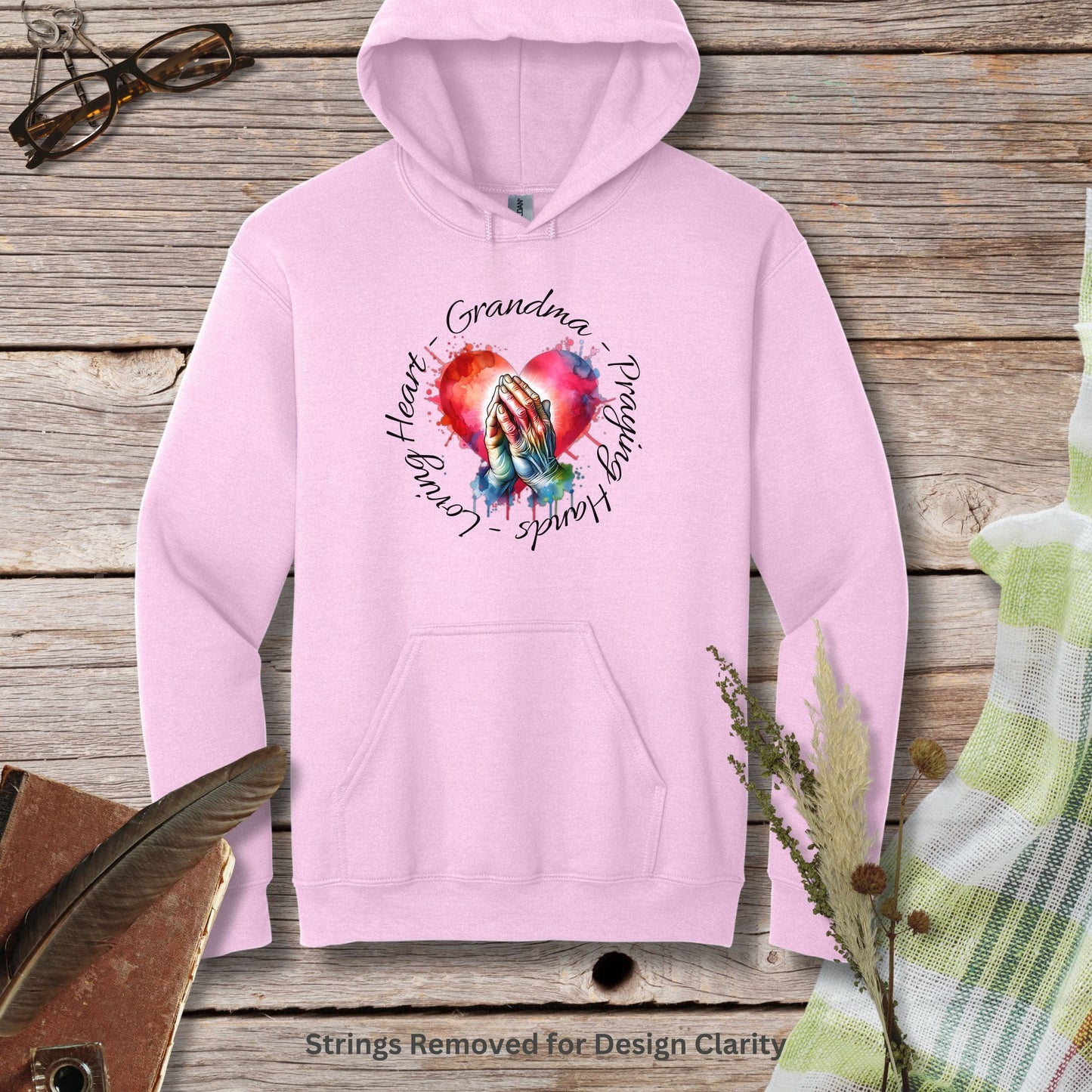 a pink hoodie with a heart and two hands on it