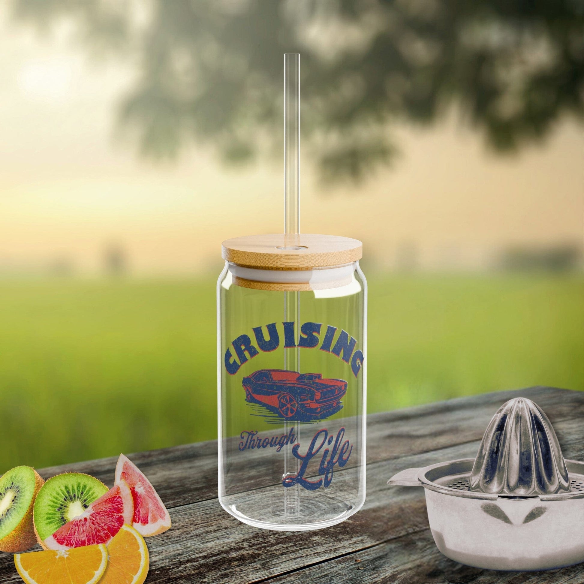 a glass jar with a straw is sitting on a picnic table