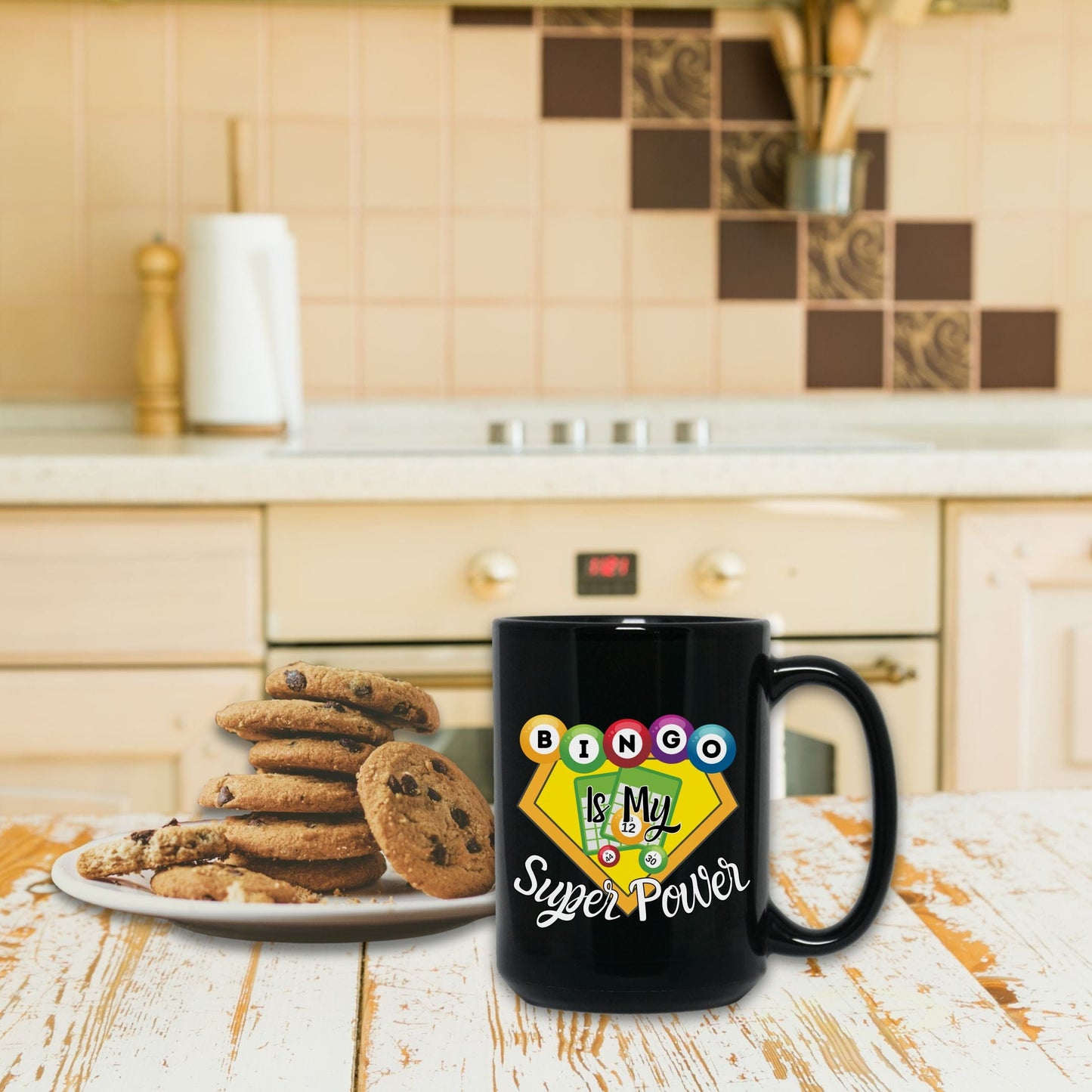 a black coffee mug sitting on top of a wooden table