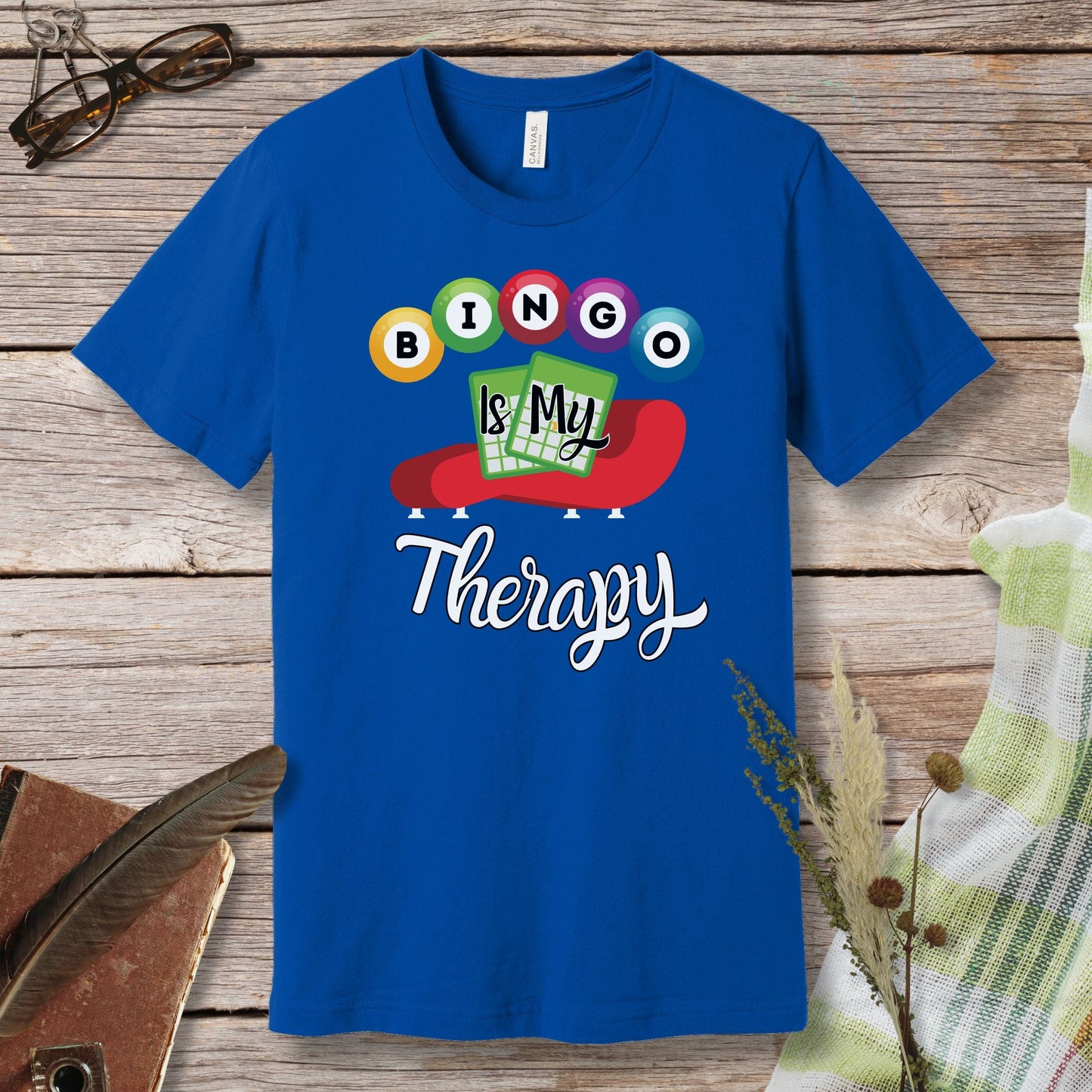 a blue t - shirt that says bingo is my therapy