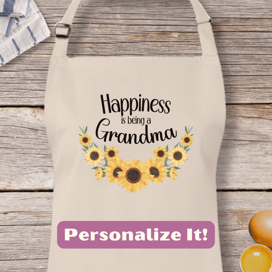 a personalized apron with sunflowers and the words happiness is being a grandma