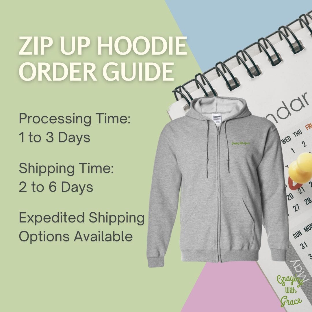 a zip - up hoodie is on a table next to a calendar