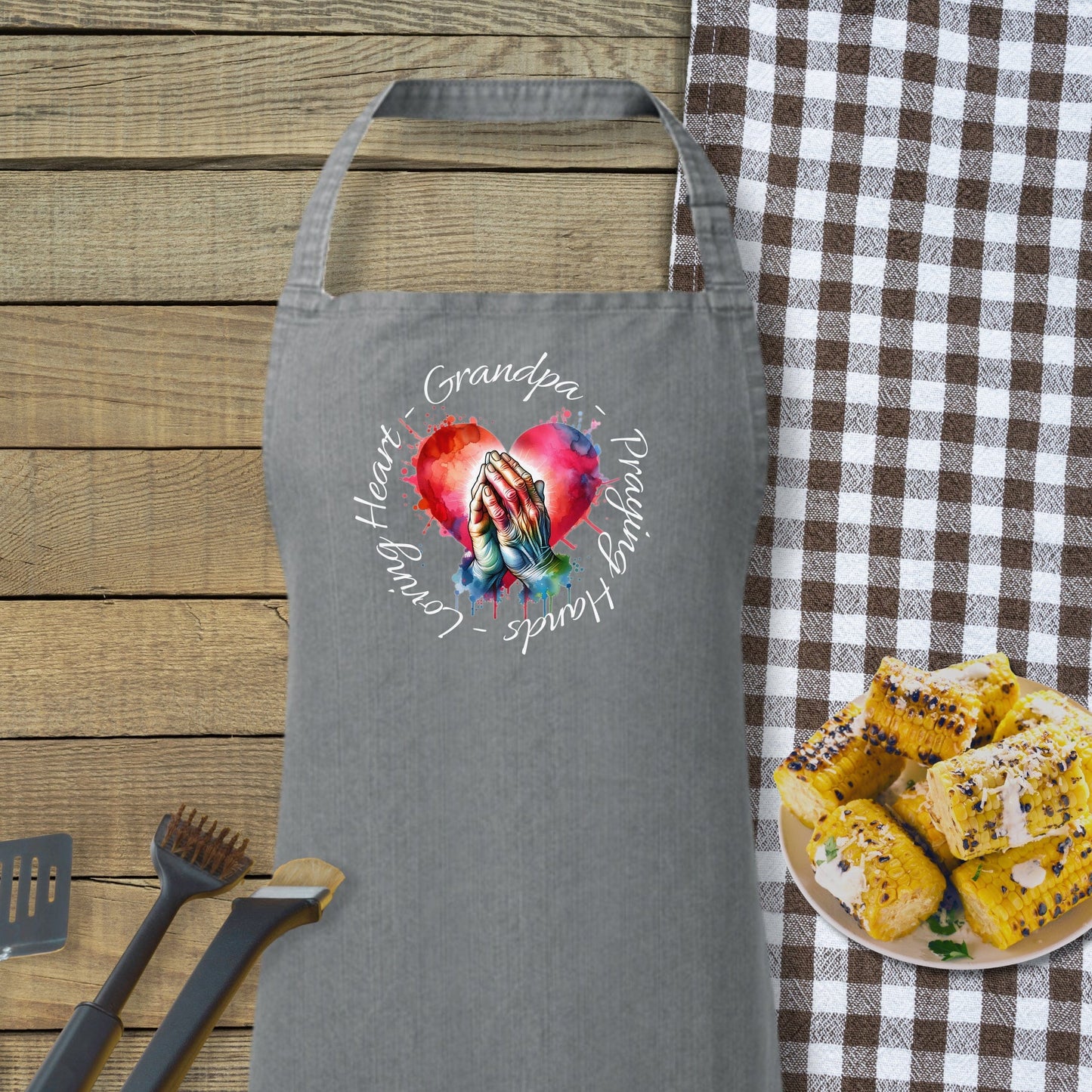 a gray apron with a picture of a hand holding a heart